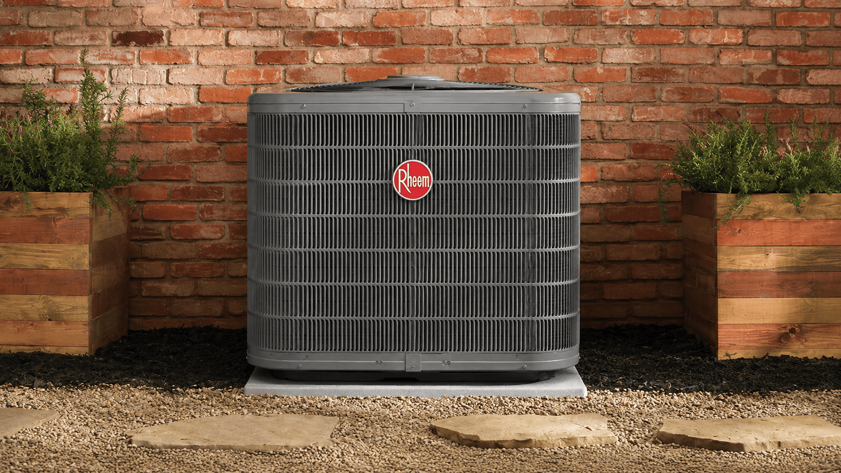 Rheem outdoor air conditioner installed against a brick wall